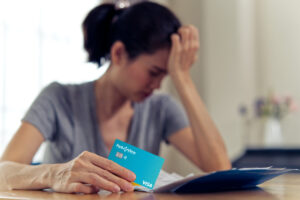 Young Adult Woman upset holding a Park View Credit Card