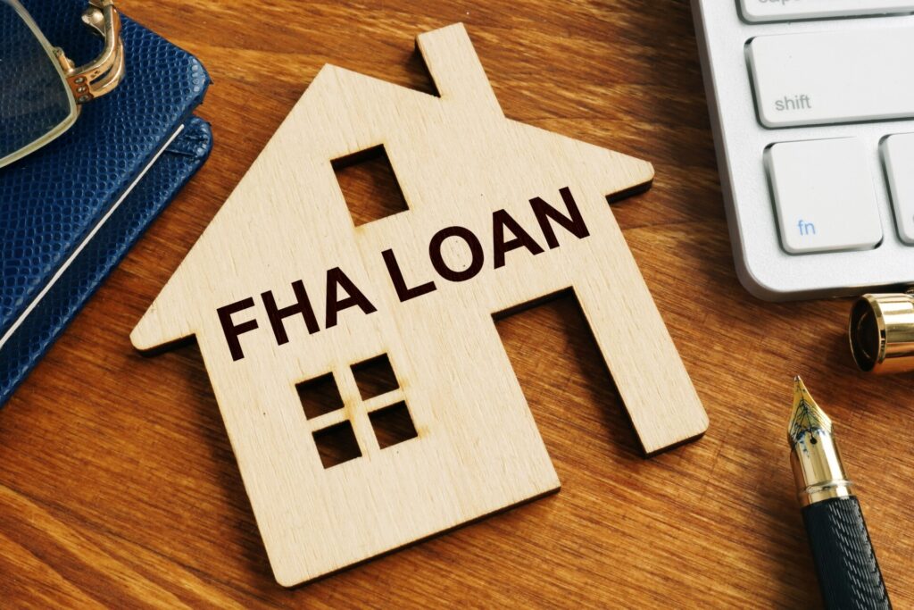An image of a wood house that says "FHA Loan"