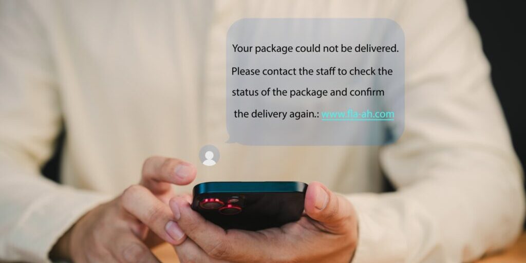 Person holds a smartphone displaying a notification about a failed package delivery. This message user to contact support and confirm delivery. Fake Text message SMS scam or phishing concept