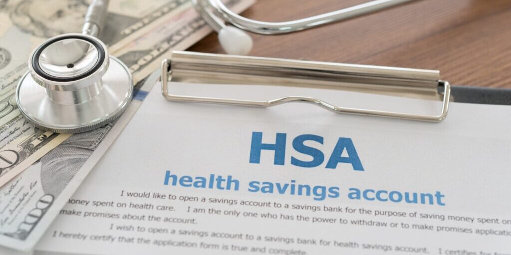 Depiction of a health savings account alongside money and a stethoscope, emphasizing the benefits of opening a health savings account.